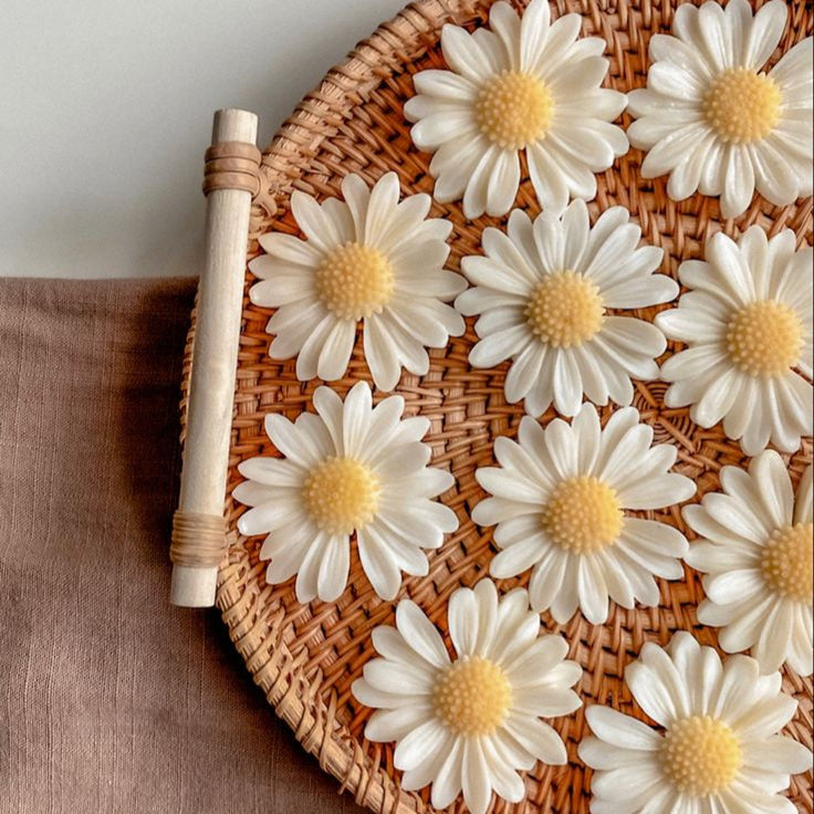 Wicker tray with white flowers on a brown fabric background